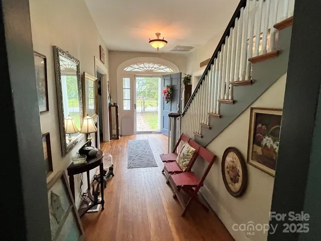 a view of entryway livingroom and hall with wooden floor
