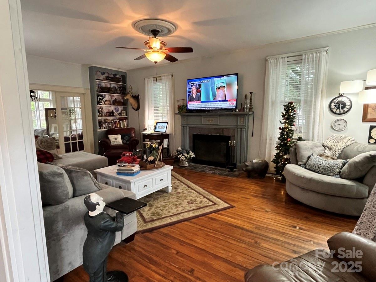 423 East Main Street Conway, NC 27820 - Photo 34 of 44 a living room with furniture a fireplace and a flat screen tv