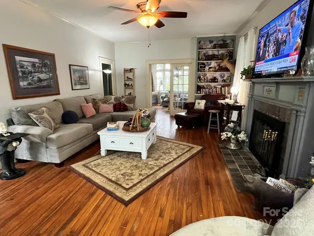 a living room with furniture fireplace and window