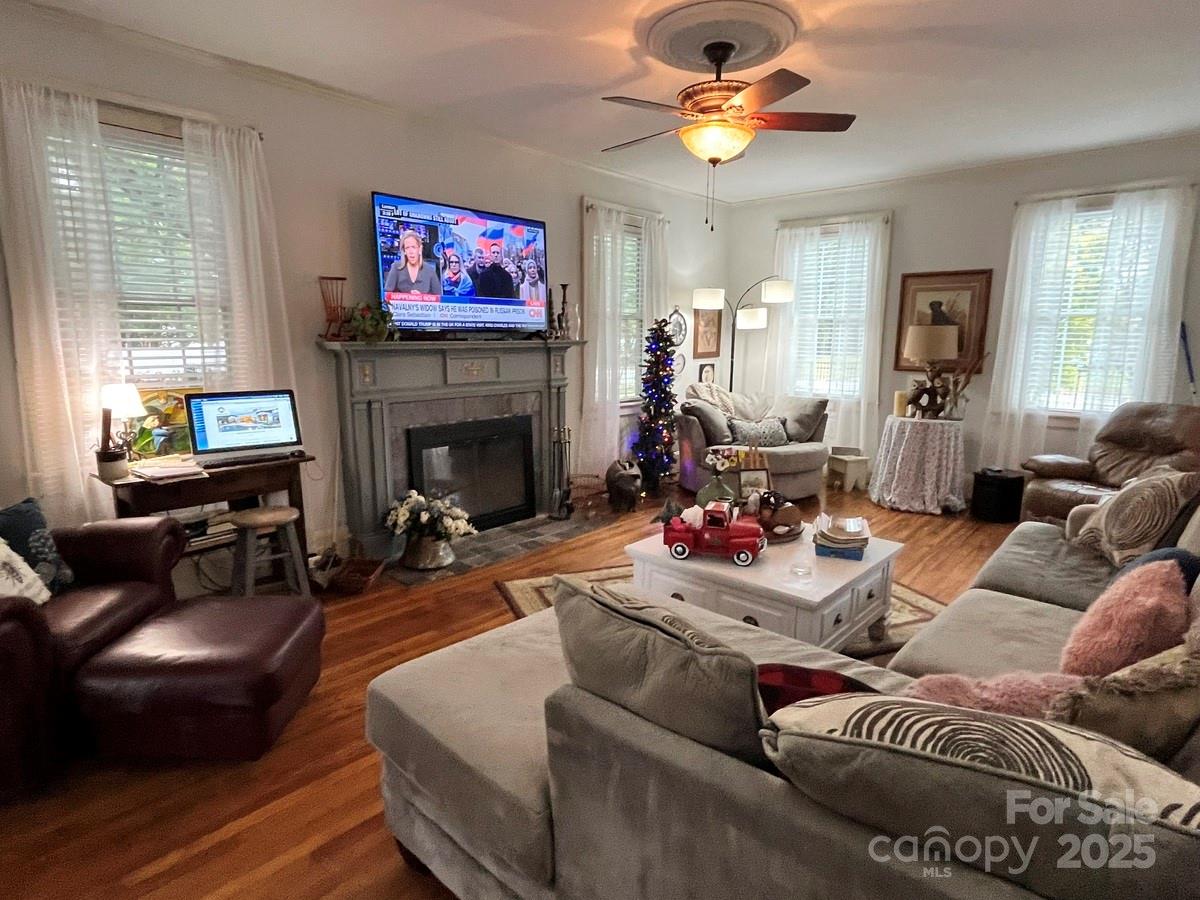 423 East Main Street Conway, NC 27820 - Photo 37 of 44 a living room with furniture a fireplace and a chandelier
