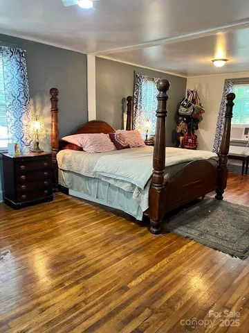 a bedroom with a bed and window
