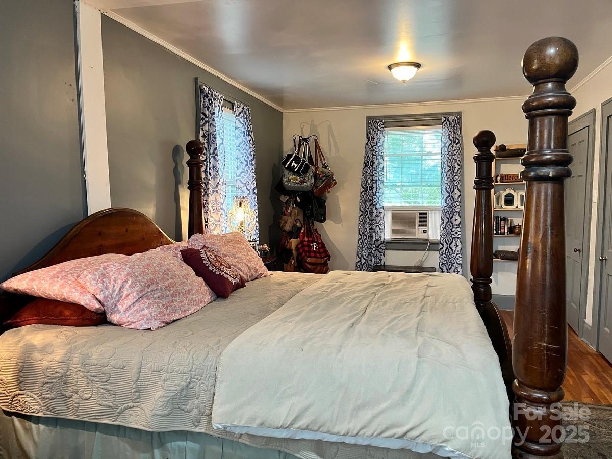 423 East Main Street Conway, NC 27820 - Photo 7 of 44 a bedroom with a bed and a chandelier