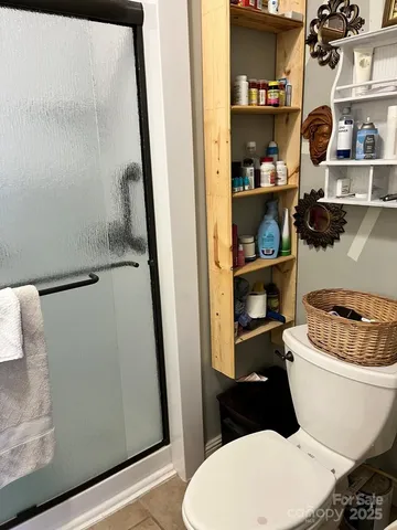 a bathroom with a toilet and a shower