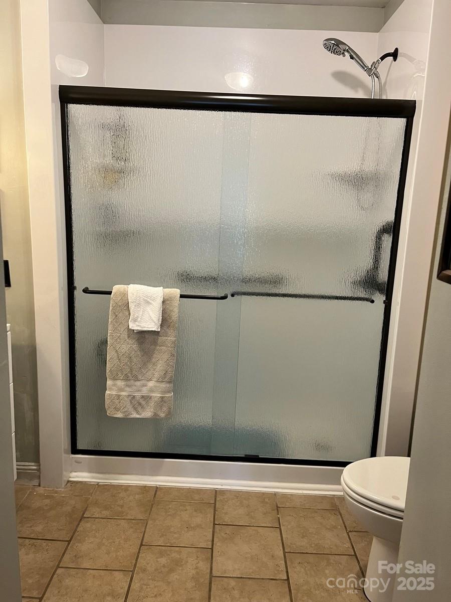 423 East Main Street Conway, NC 27820 - Photo 10 of 44 a view of bathroom with a shower and a toilet
