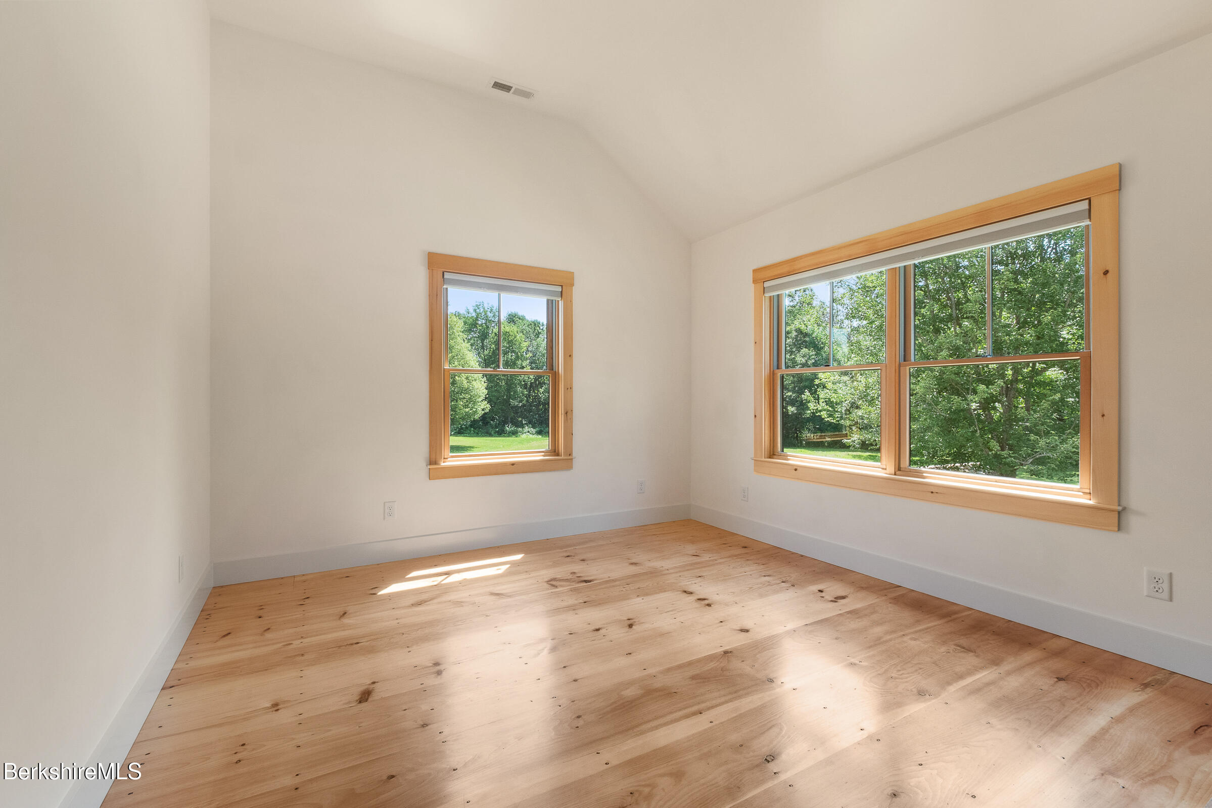 194 Sandisfield Road Sandisfield, MA 01255 - Photo 46 of 59 an empty room with wooden floor and windows