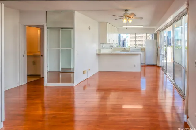 a view of a kitchen with wooden floor and a kitchen