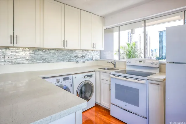 a kitchen with a stove top oven sink and cabinets