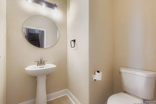 a bathroom with a sink a mirror and a toilet