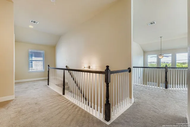 a view of a hallway with window and stairs