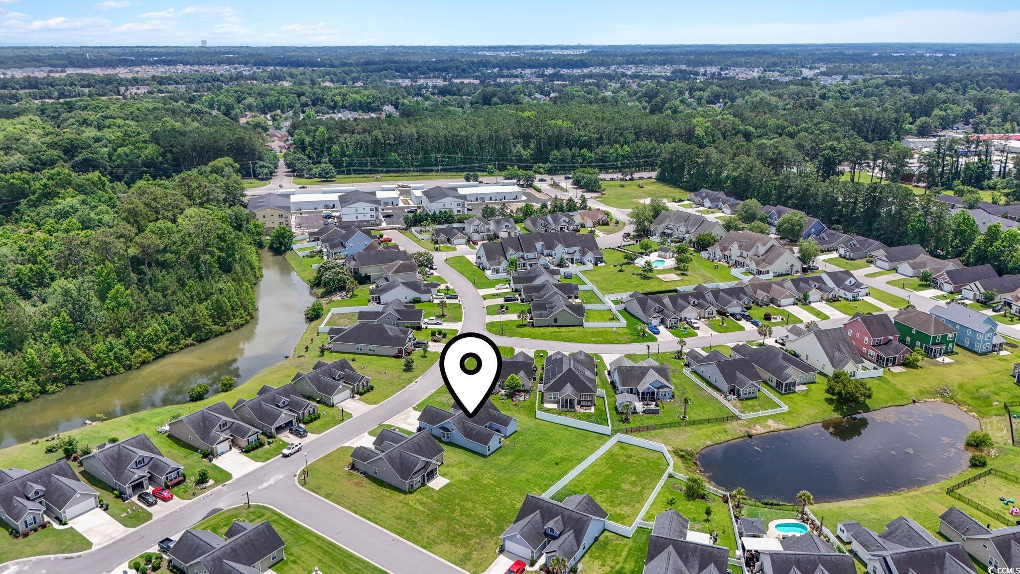 282 Foxpath Loop Myrtle Beach, SC 29588 - Photo 32 of 34 Aerial view of residential area with a large body of water and a forest