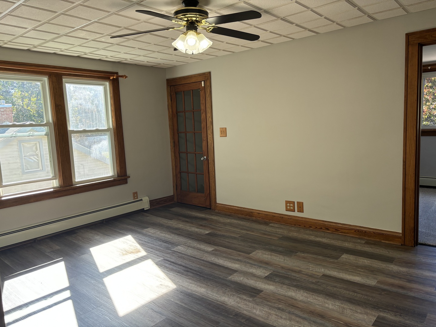 912 Clay Street Woodstock, IL 60098 - Photo 10 of 15 an empty room with wooden floor fan and windows