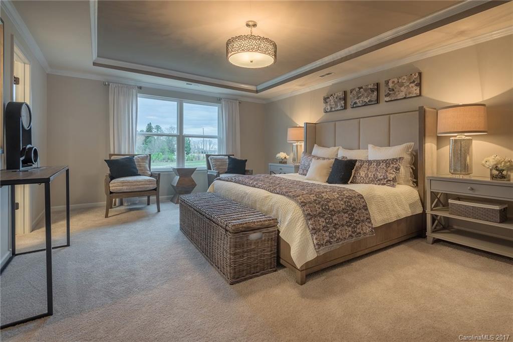 257 Keating Pl Drive, Unit 46 Fort Mill, SC 29708 - Photo 2 of 24 a bedroom with a bed lamps and window