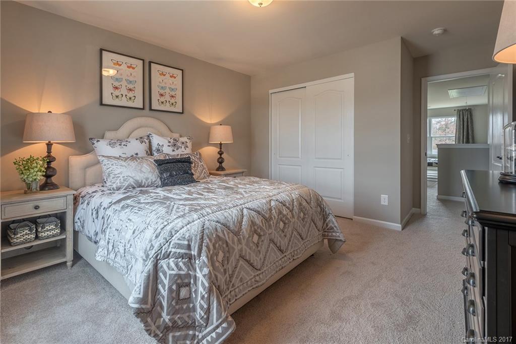 257 Keating Pl Drive, Unit 46 Fort Mill, SC 29708 - Photo 13 of 24 a bedroom with a bed and a lamp on table