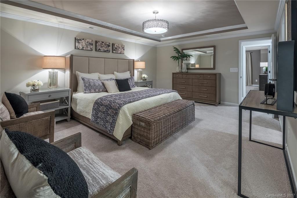 257 Keating Pl Drive, Unit 46 Fort Mill, SC 29708 - Photo 3 of 24 a spacious bedroom with a bed window and a dresser