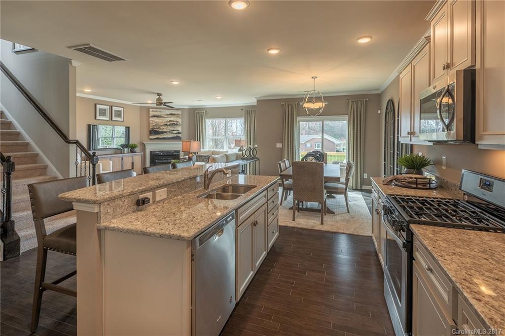257 Keating Pl Drive, Unit 46 Fort Mill, SC 29708 - Photo 22 of 24 a kitchen with stainless steel appliances granite countertop a sink stove and cabinets