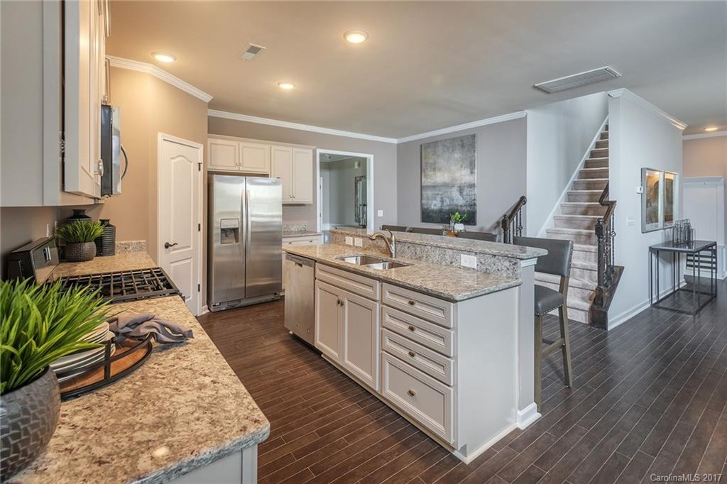 257 Keating Pl Drive, Unit 46 Fort Mill, SC 29708 - Photo 23 of 24 a kitchen with stainless steel appliances granite countertop a stove a sink dishwasher and a refrigerator