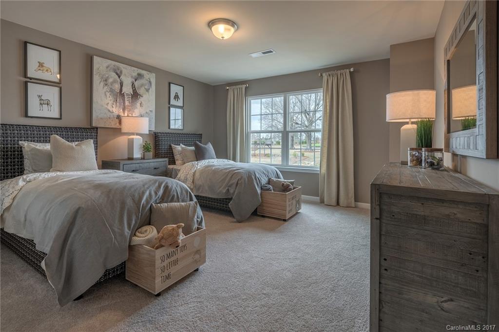 257 Keating Pl Drive, Unit 46 Fort Mill, SC 29708 - Photo 9 of 24 a spacious bedroom with two beds and a large window