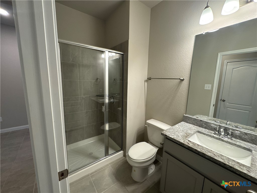 2214 Wasabi Road Temple, TX 76501 - Photo 11 of 26 a bathroom with a granite countertop sink toilet and shower