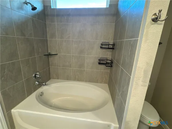 a white bath tub sitting in a bathroom