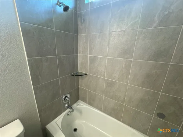 a bathroom with a shower a toilet and a sink