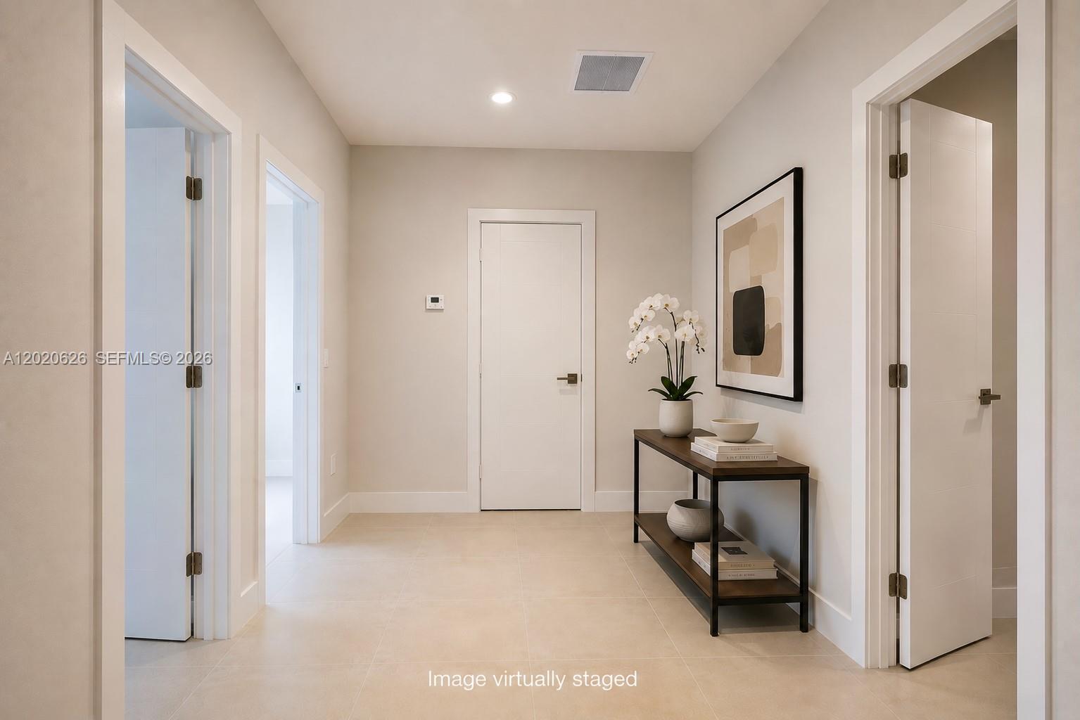 7701 Southwest 95th Terrace, Unit 1 Miami, FL 33156 - Photo 8 of 18 a view of an entryway with table and chair