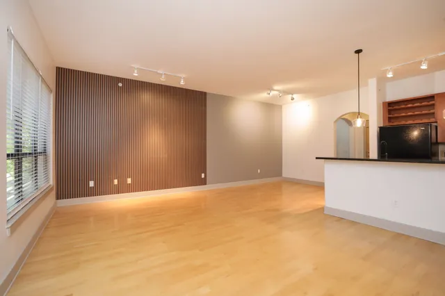 a view of an empty room with a kitchen