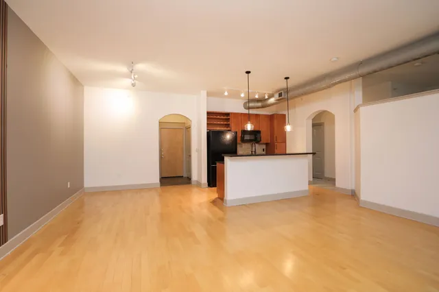 a kitchen with stainless steel appliances kitchen island a refrigerator a stove and a sink