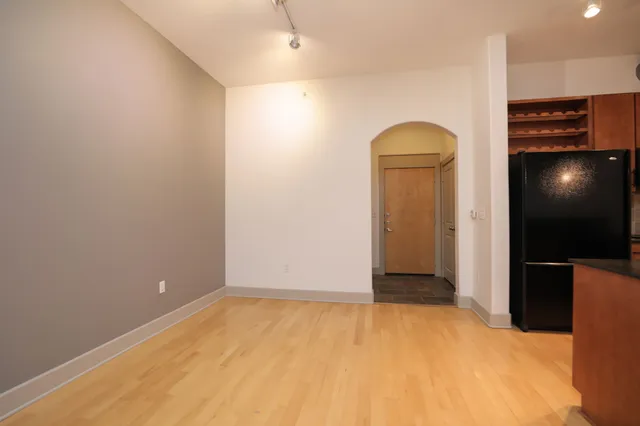 a view of a kitchen with a refrigerator and a sink