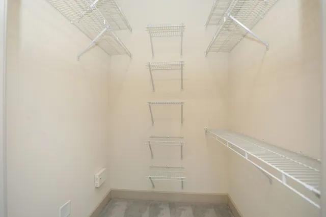 a bathroom with a granite countertop sink a mirror and a shower