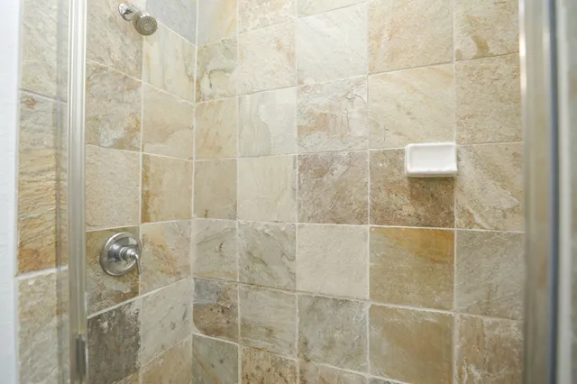 a kitchen with stainless steel appliances kitchen island granite countertop a sink a stove and a wooden floors