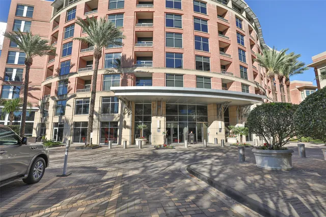 a dining room with furniture a chandelier and wooden floor