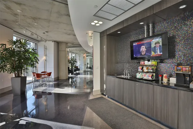 a view of a patio with couches and table and chairs and potted plants