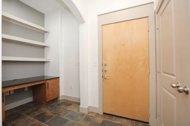 a hallway view with wooden floor