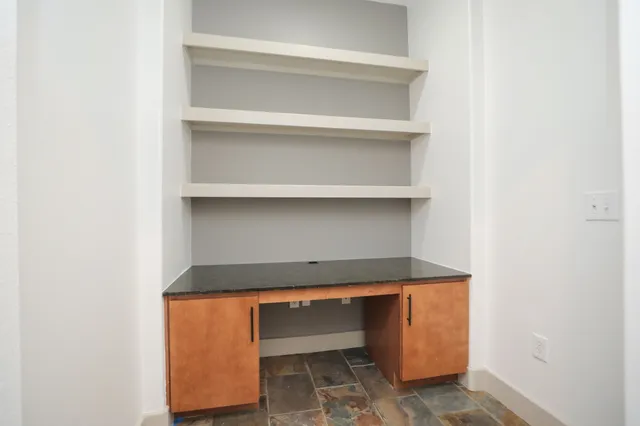a view of a kitchen with a sink and window