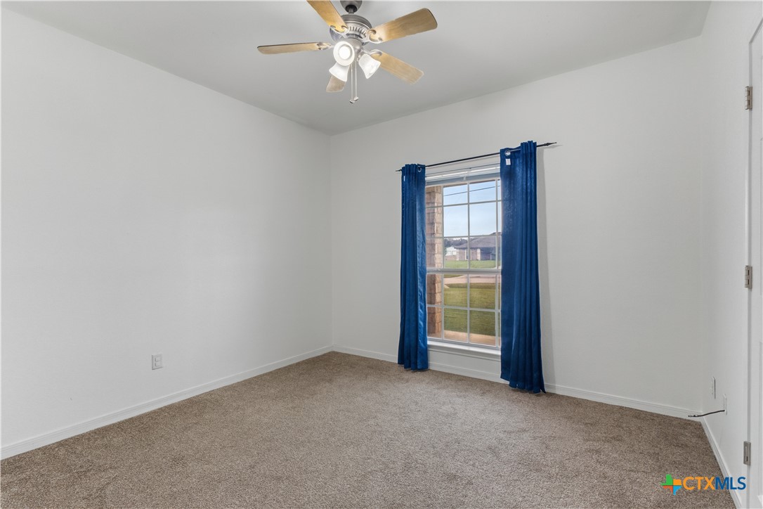 283 County Road 4710 Kempner, TX 76539 - Photo 29 of 47 an empty room with a ceiling fan and a window