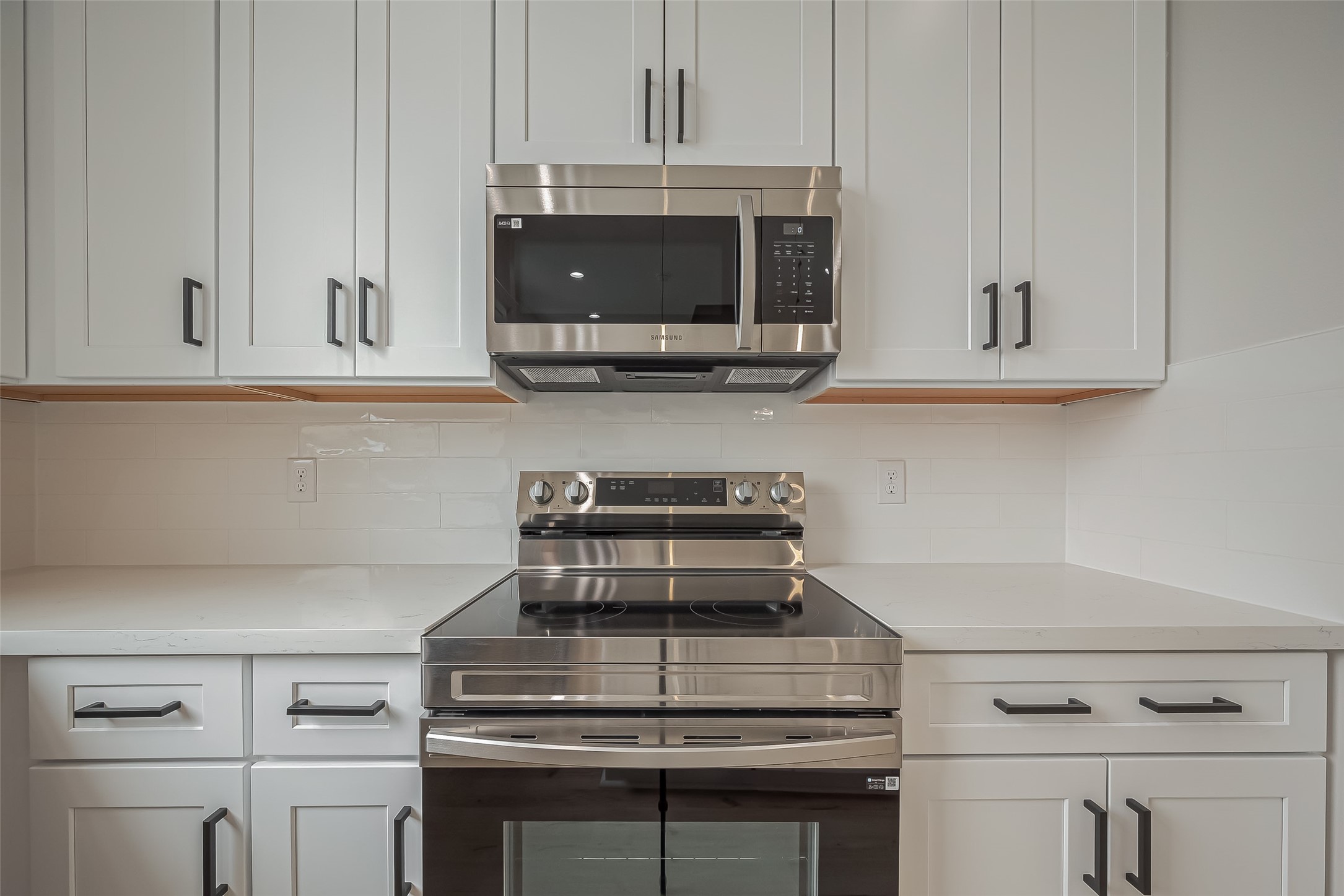 918 St Clair Street, Unit B Houston, TX 77088 - Photo 15 of 35 a kitchen with granite countertop white cabinets and stainless steel appliances