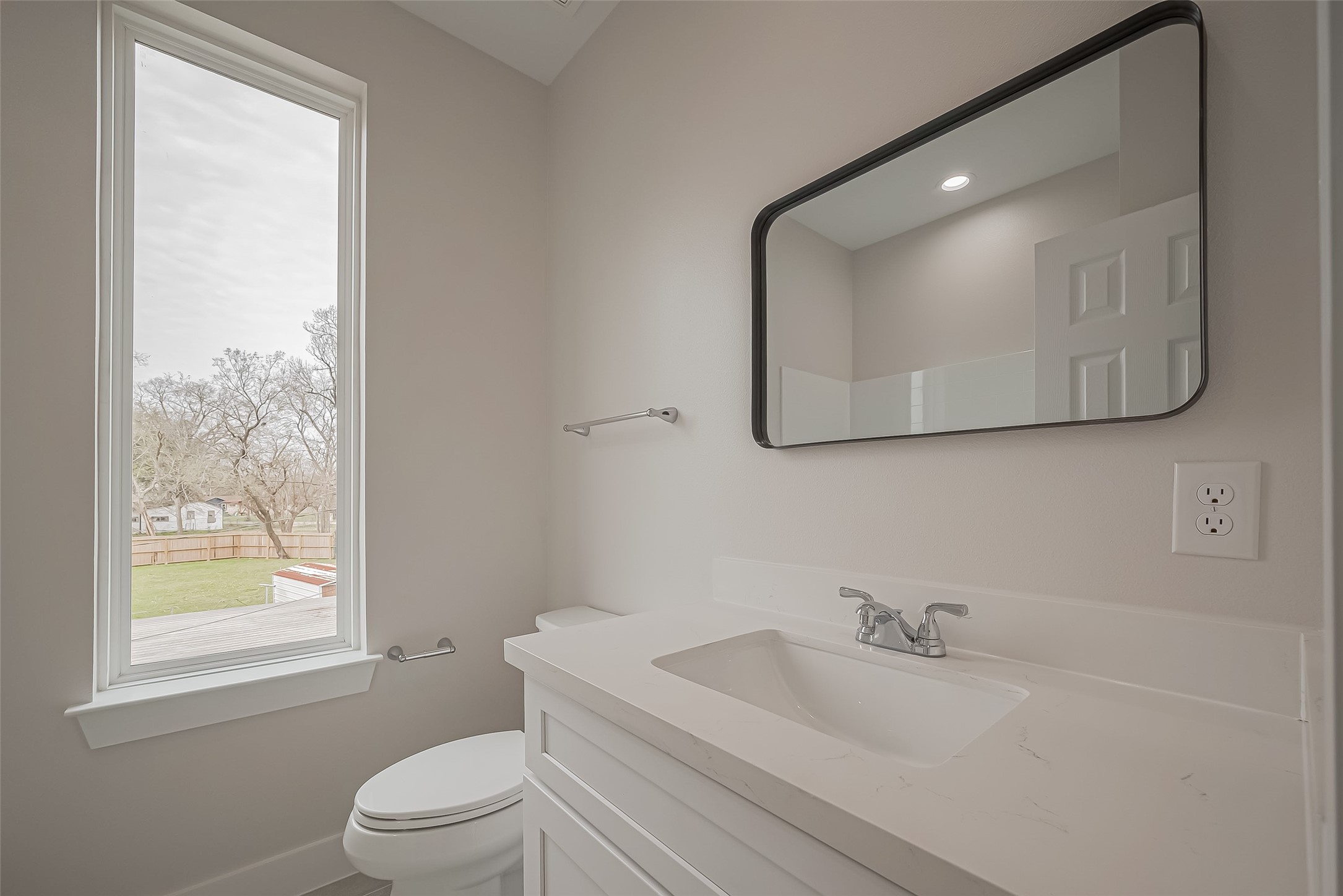 918 St Clair Street, Unit B Houston, TX 77088 - Photo 24 of 35 a bathroom with a toilet a sink a vanity and mirror