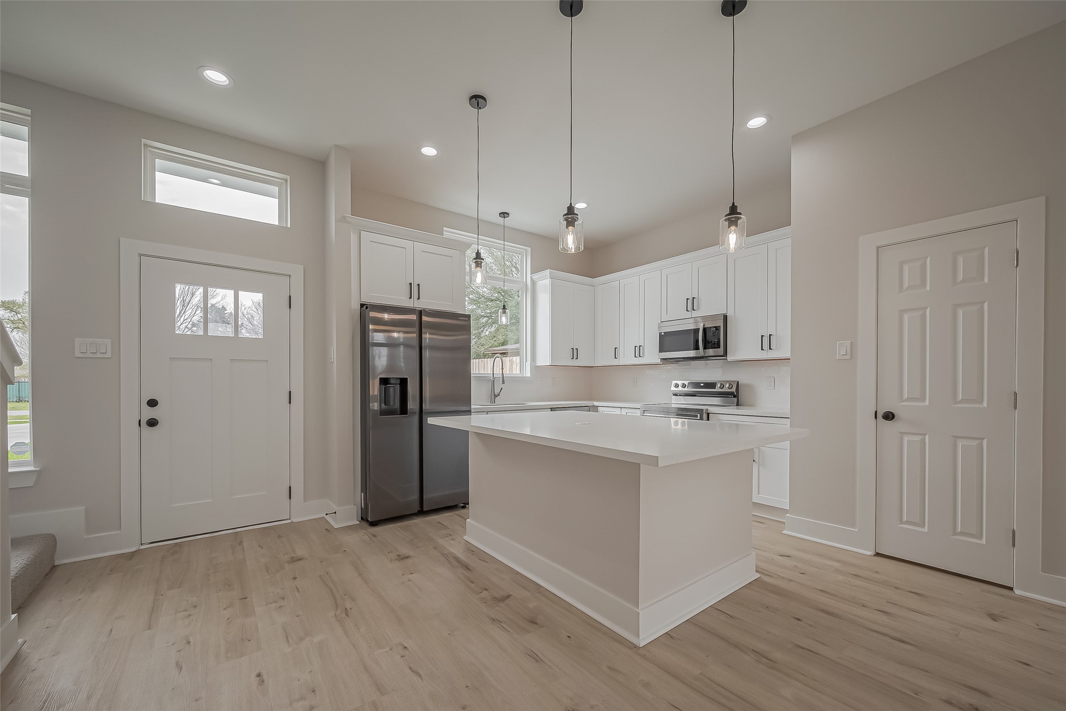 918 St Clair Street, Unit B Houston, TX 77088 - Photo 5 of 35 a kitchen with kitchen island a sink stainless steel appliances and cabinets