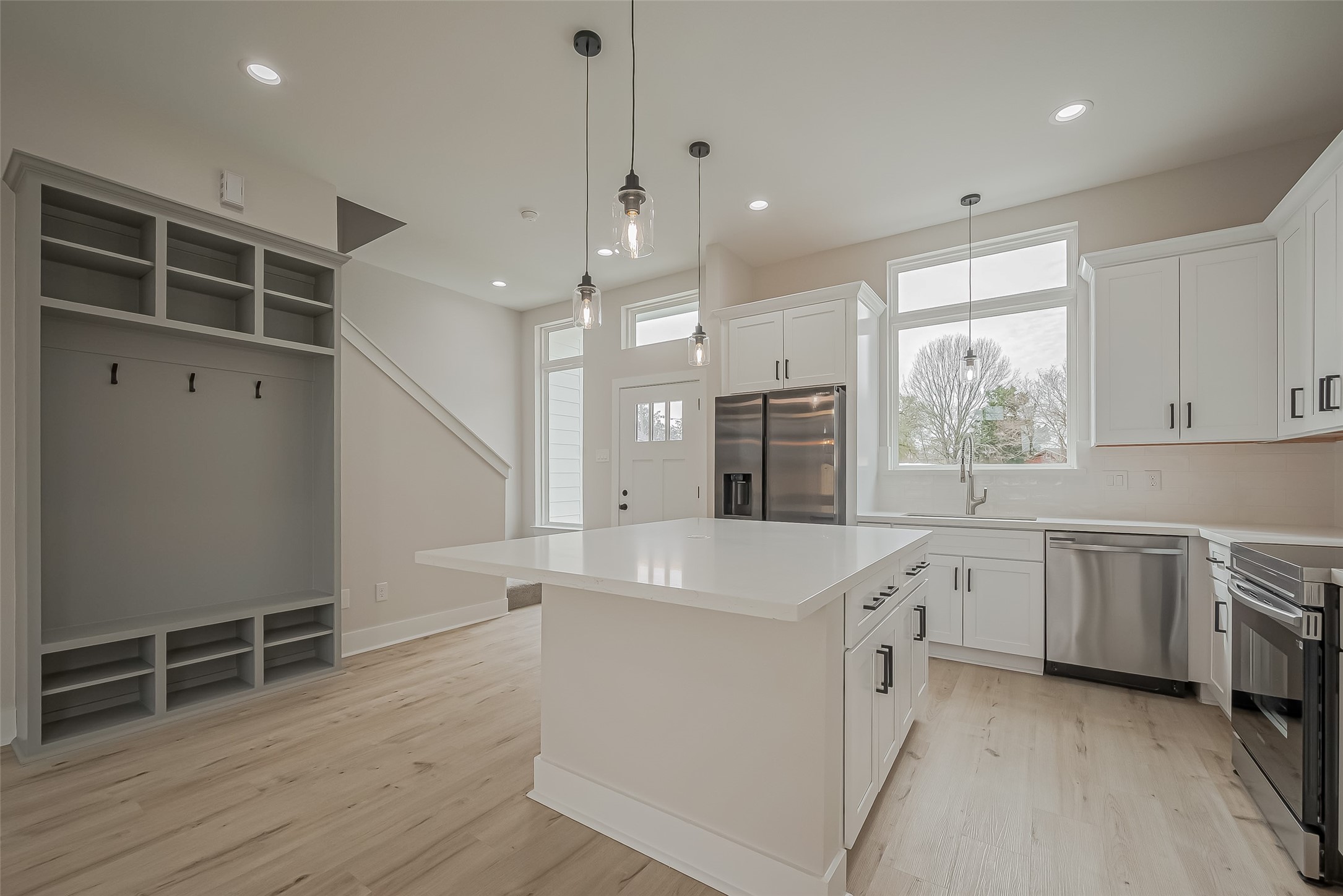 918 St Clair Street, Unit B Houston, TX 77088 - Photo 10 of 35 a large white kitchen with wooden floors and stainless steel appliances