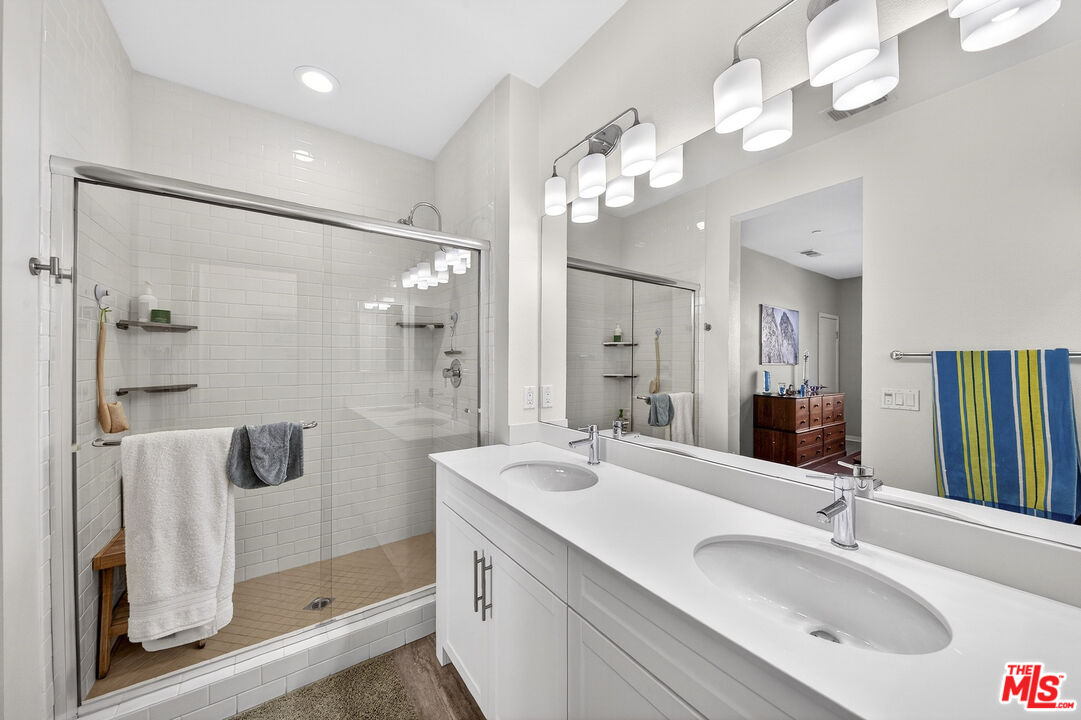 692 Colorado Circle Carson, CA 90745 - Photo 15 of 35 a bathroom with a double vanity sink a large mirror and shower