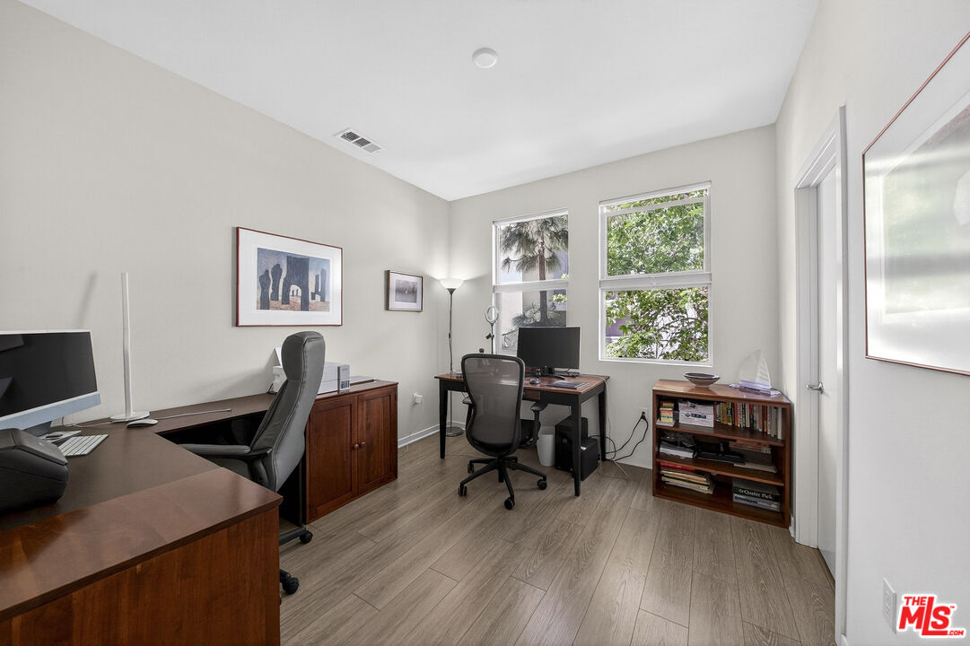 692 Colorado Circle Carson, CA 90745 - Photo 18 of 35 a view of a workspace with furniture and a window