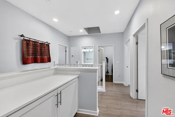 a kitchen with a refrigerator and a stove top oven