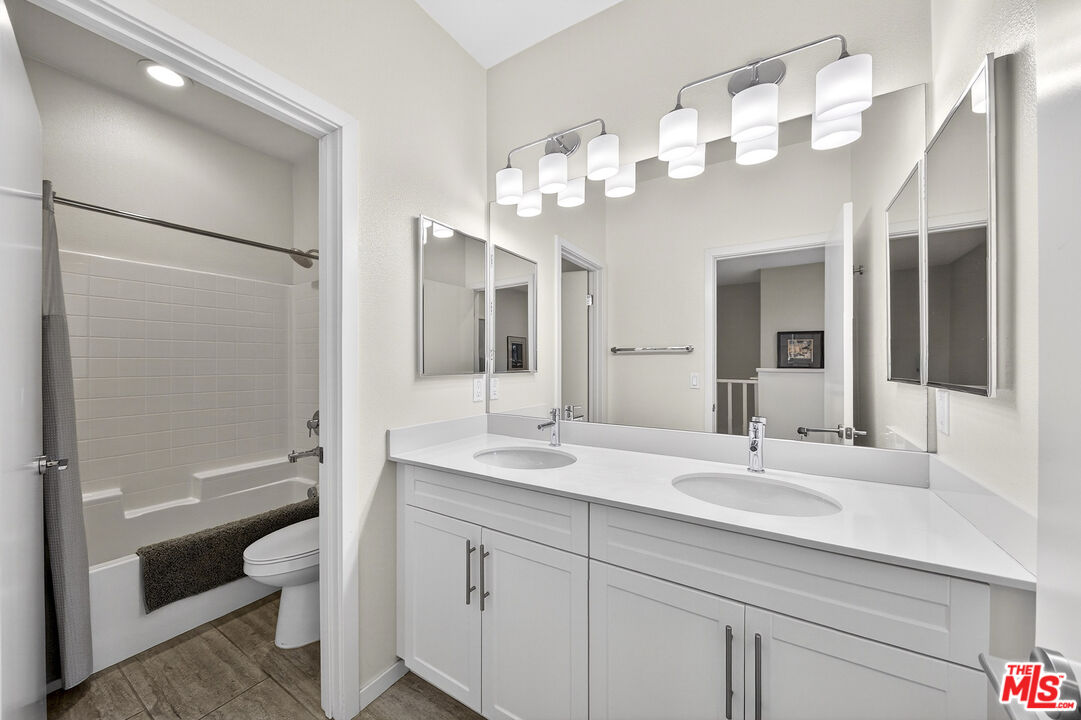 692 Colorado Circle Carson, CA 90745 - Photo 19 of 35 a bathroom with a sink a toilet and a large mirror