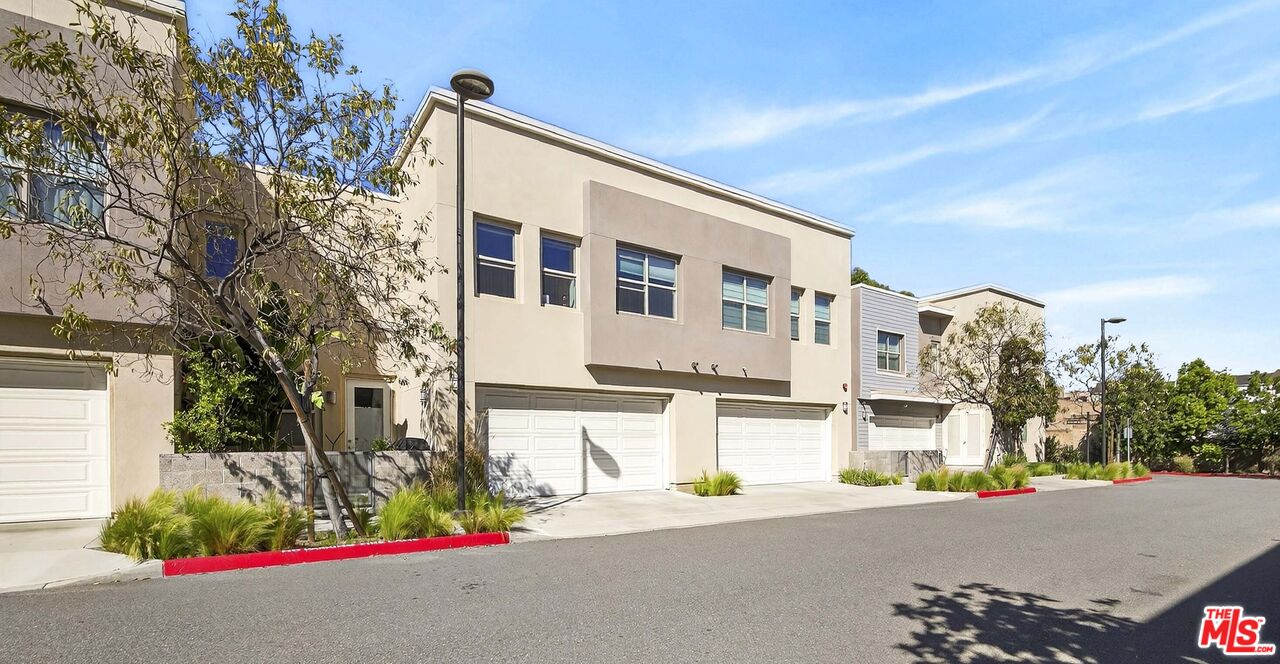 692 Colorado Circle Carson, CA 90745 - Photo 23 of 35 a front view of a house with a road and garage