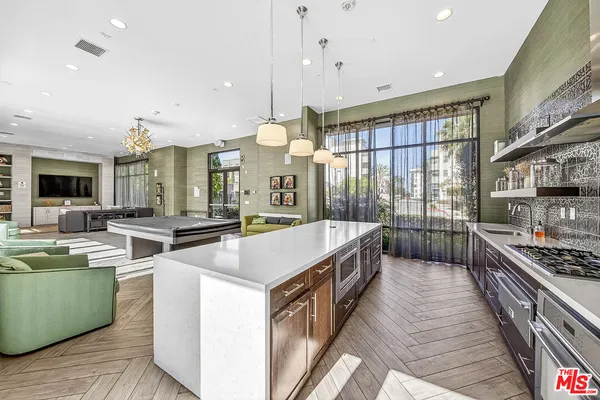 a kitchen with stainless steel appliances granite countertop a sink and a stove