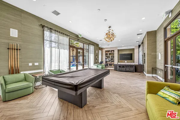 a living room with furniture and large windows