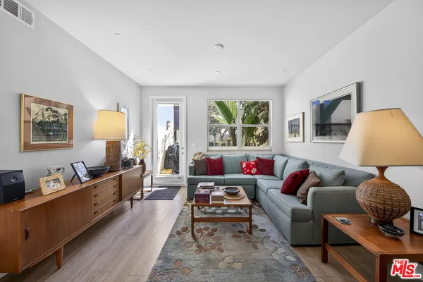 a living room with furniture and a lamp