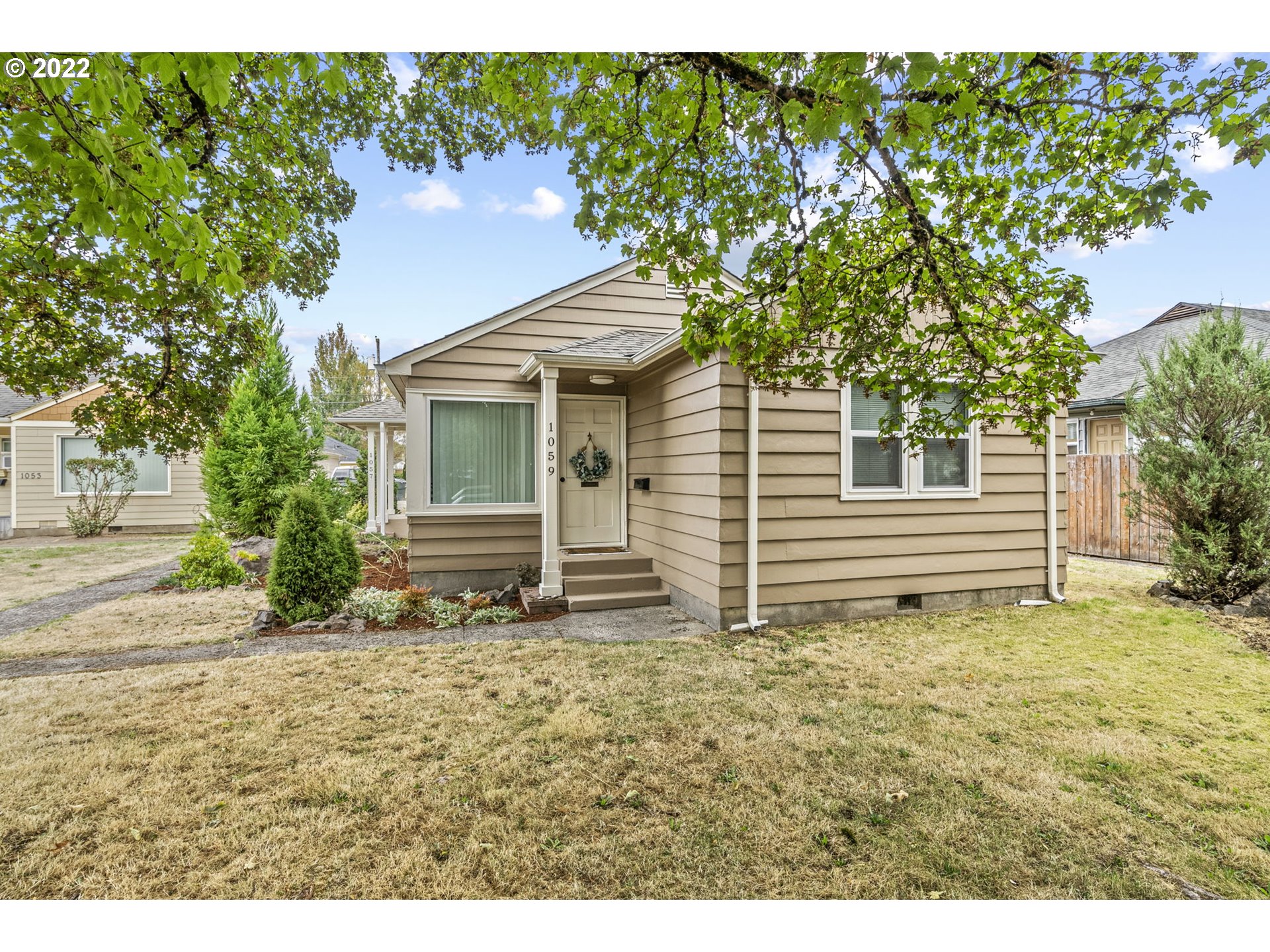 1057 17th Avenue Longview, WA 98632 - Photo 1 of 30 a house with trees in the background