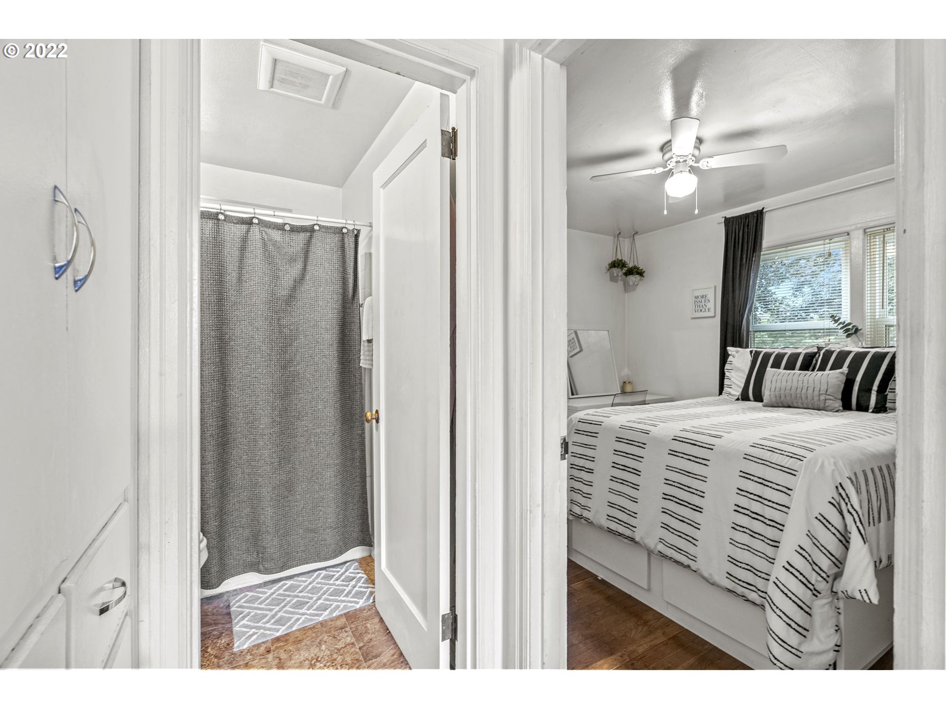 1057 17th Avenue Longview, WA 98632 - Photo 11 of 30 a bedroom with a large bed and a chandelier
