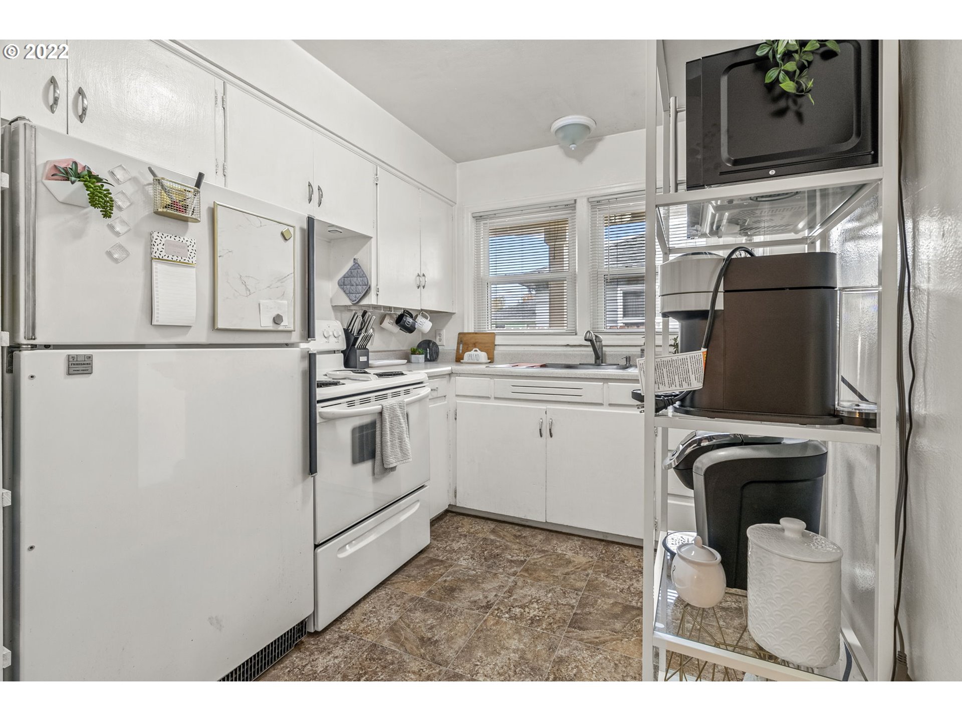 1057 17th Avenue Longview, WA 98632 - Photo 14 of 30 a kitchen with stainless steel appliances a refrigerator sink and cabinets